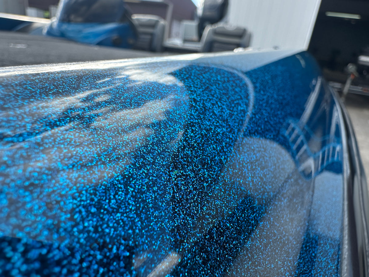 Close-up of a glossy blue fiberglass boat finish