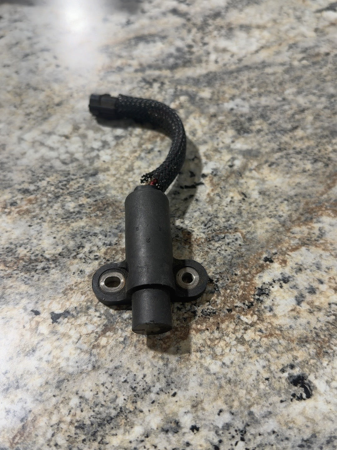 Actual used Mercury crankshaft position sensor 8M0082988 showing attached lead and sleeve wear